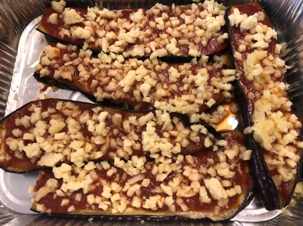 Grated cheese on tomato sauce on eggplant