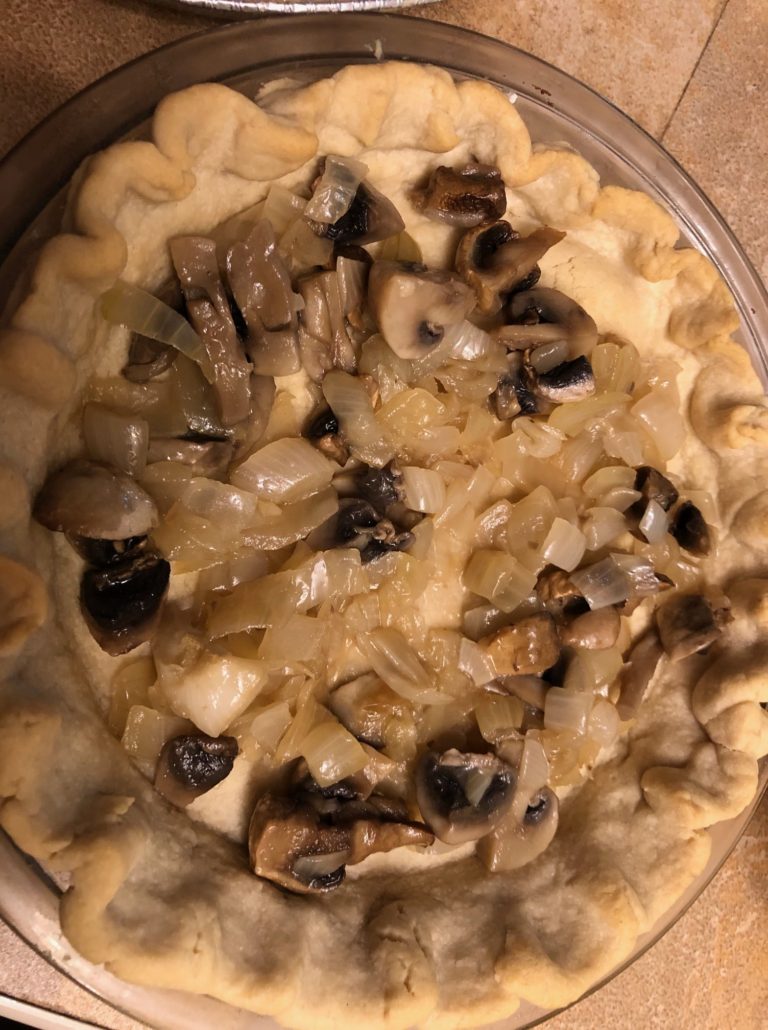 Prebaked crust with onion mushroom filling