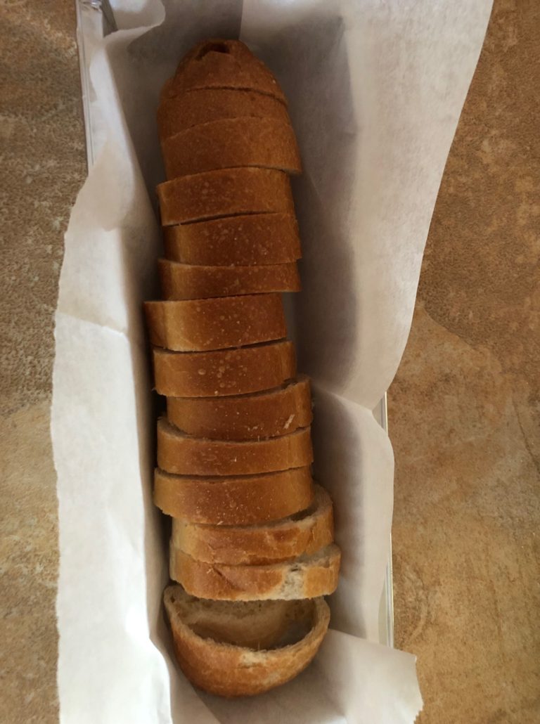 Cut up baguette in parchment paper lined pan