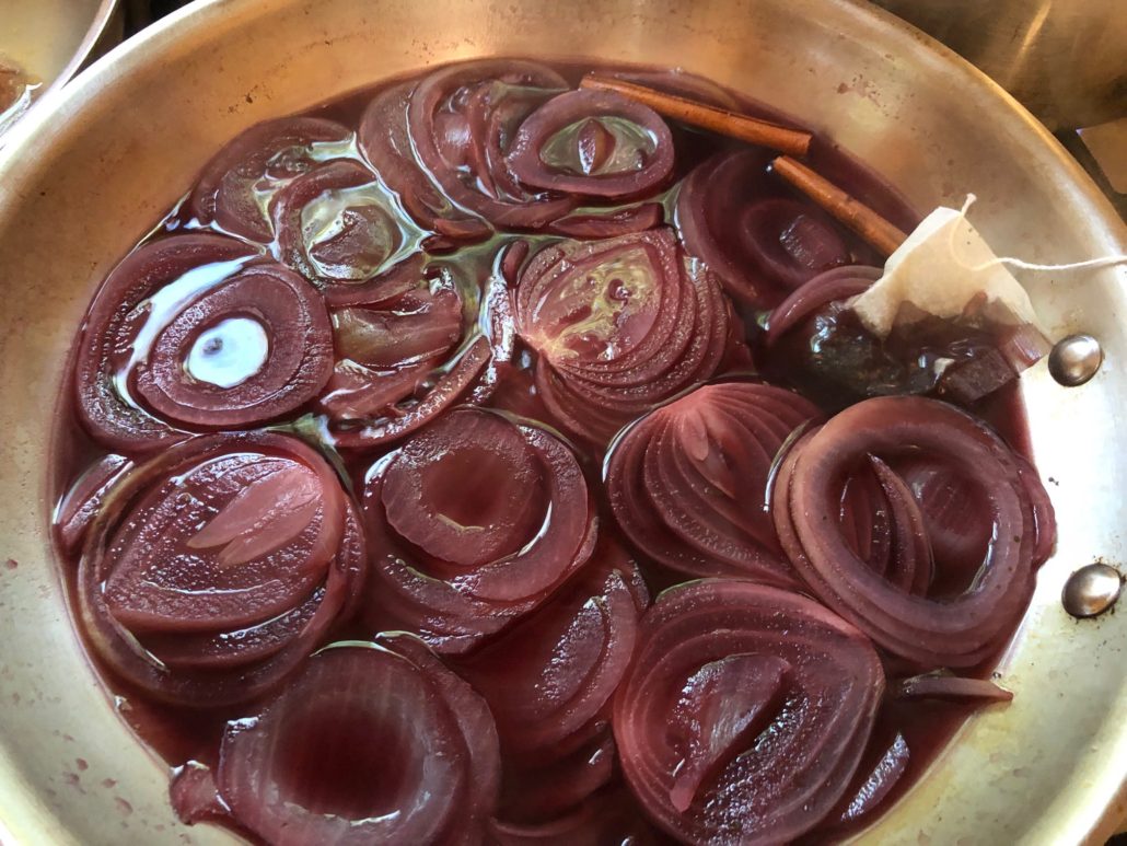 Onions sliced into rings in red wine and cherry juice