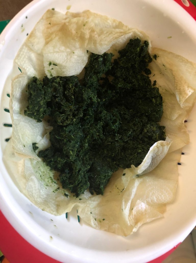 Spinach defrosting in colander
