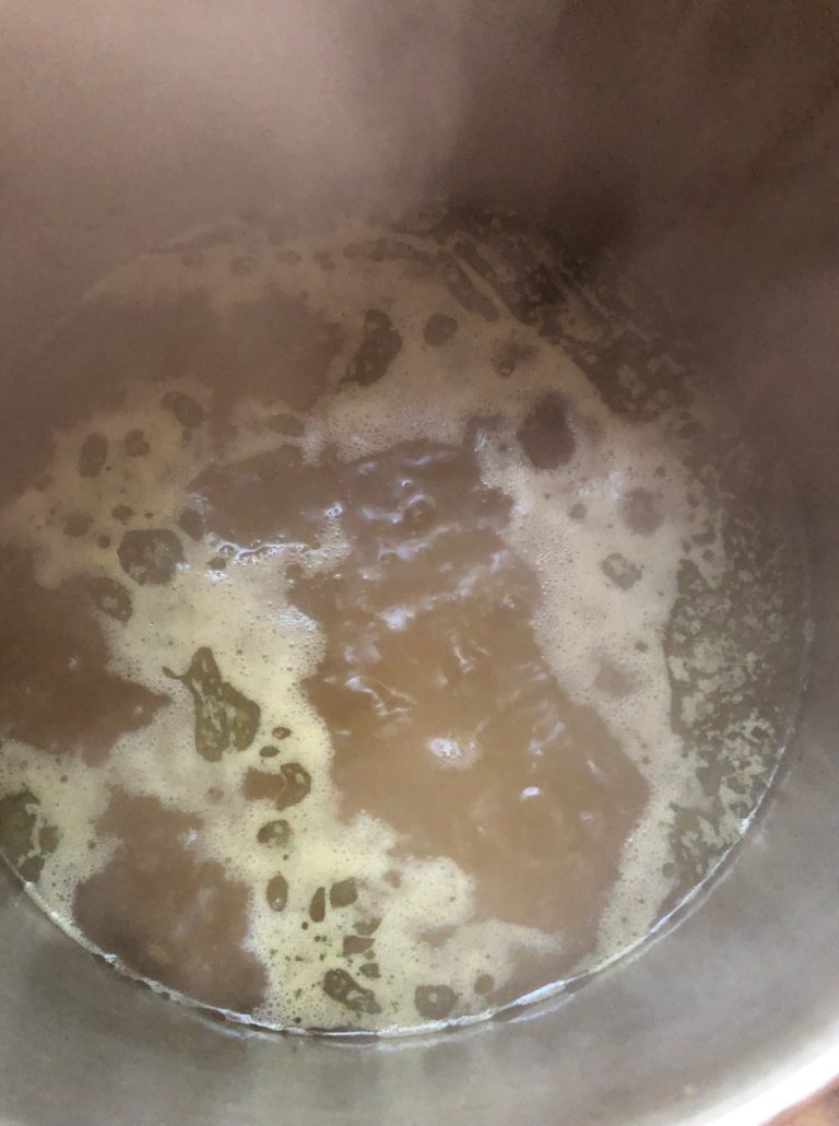 bringing the water, spices and rice back to the boil