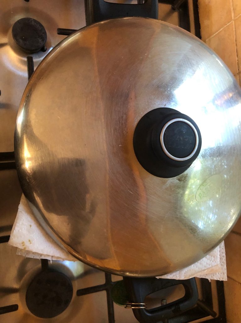 Letting rice steam in pot with towel 