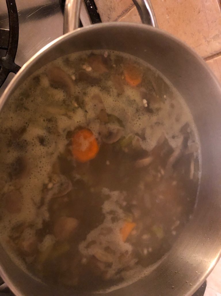 The mushroom barely soup coming to the boil
