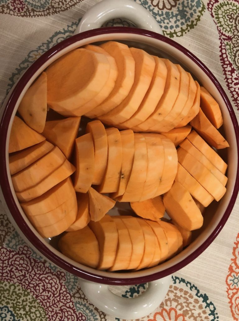 Sweet potatoes cut in 1/2 inch slices in oven to table baking dish