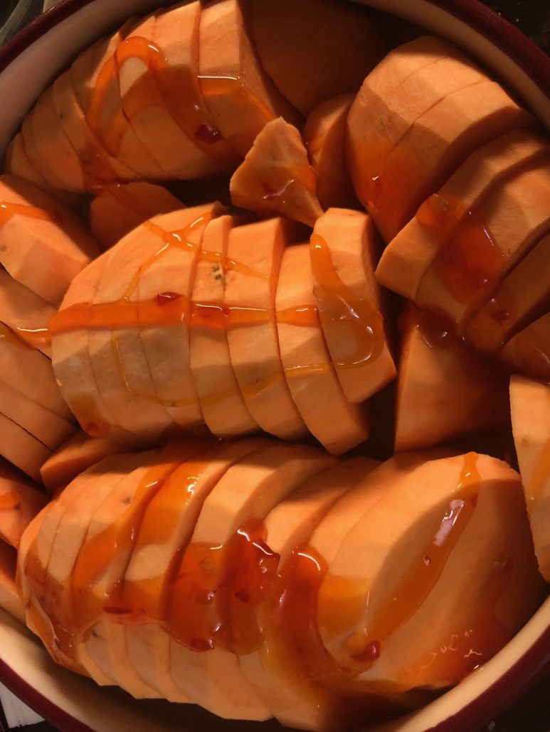 Sweet chili sauce drizzled over sweet potatoes