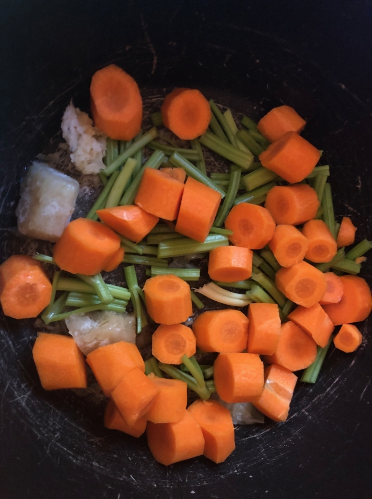 chopped carrots and celery on onion and garlic