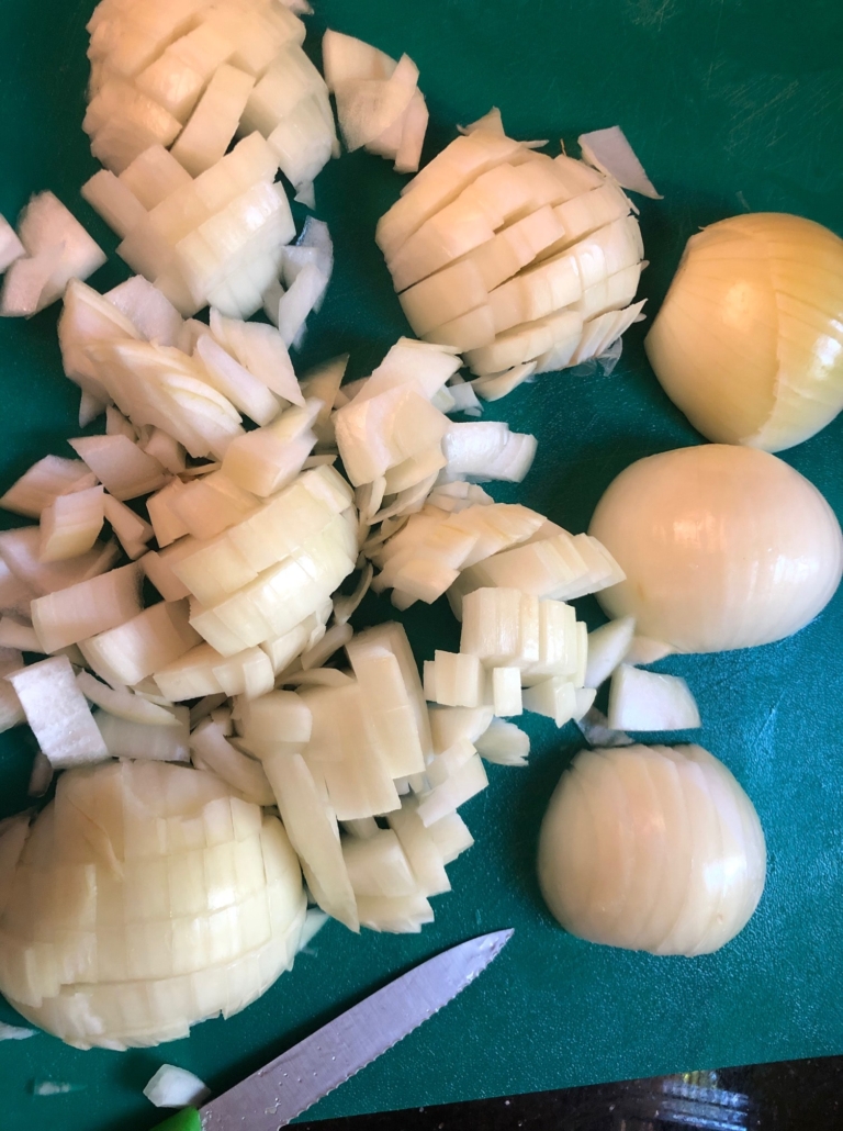 chopping onions on cutting board