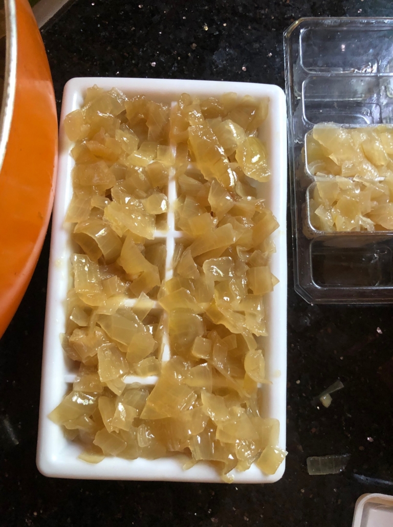 Chopped sauteed onions in ice cube tray