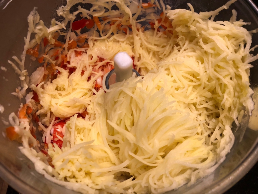 shredded potatoes in onion and peppers