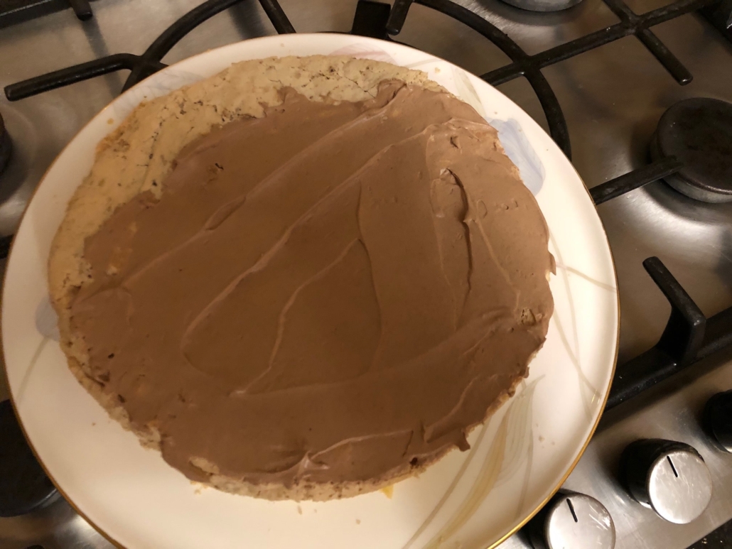 slathering the cake with frosting