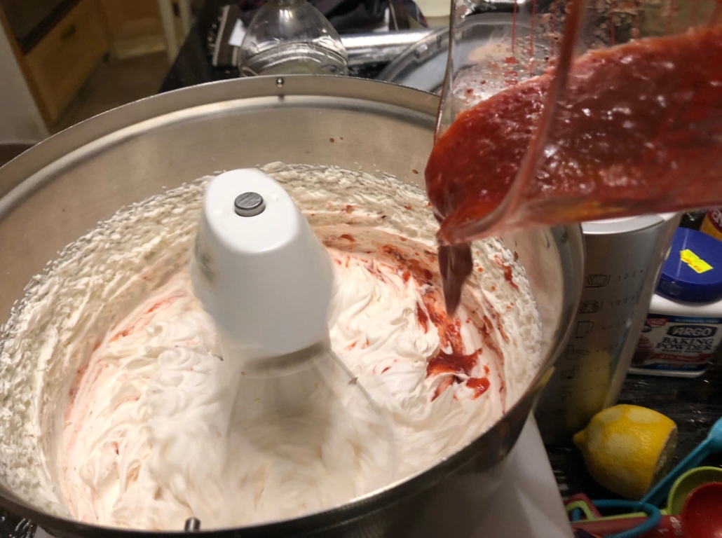 adding strawberry mixture to whipped cream