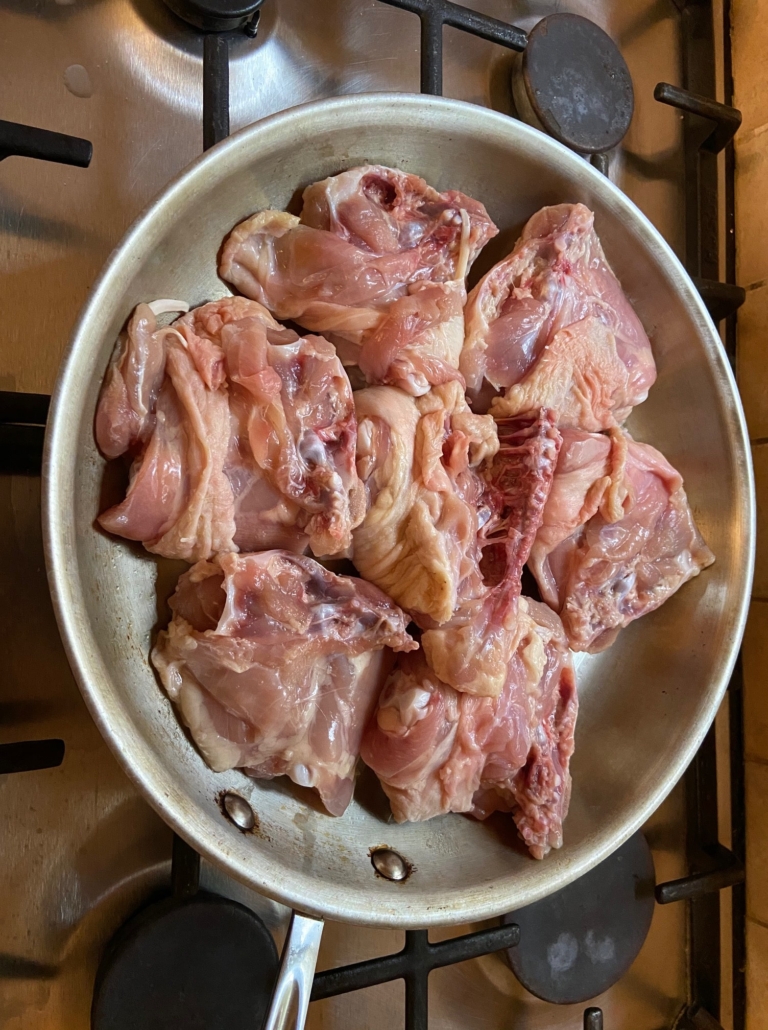 Chicken skin side down in pan