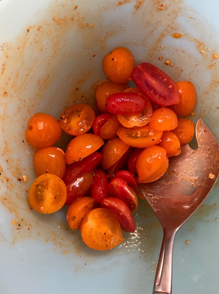 Cut tomatoes in bowl with dressing