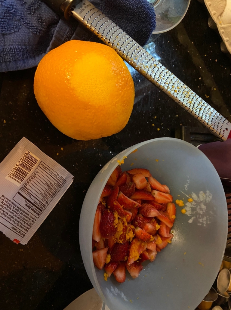 Grating the peel and quartering the berries