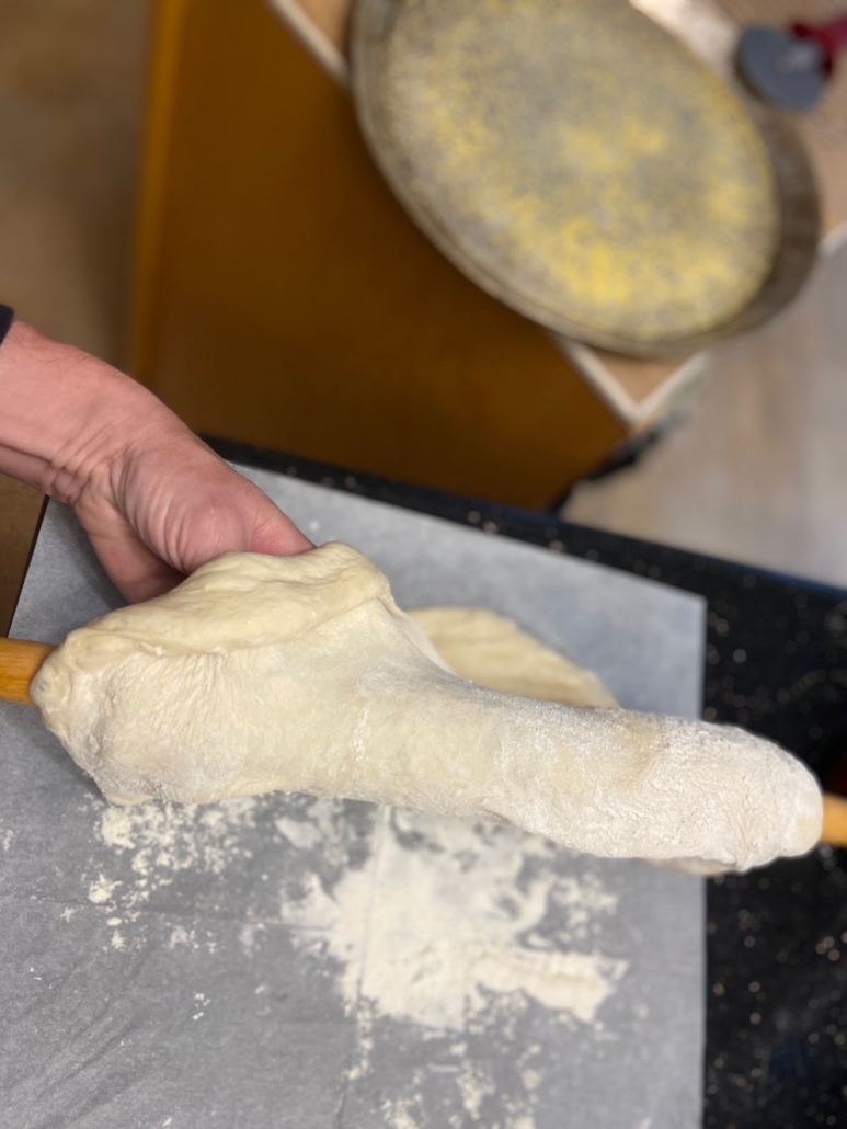 fold dough over rolling pin to put on pan