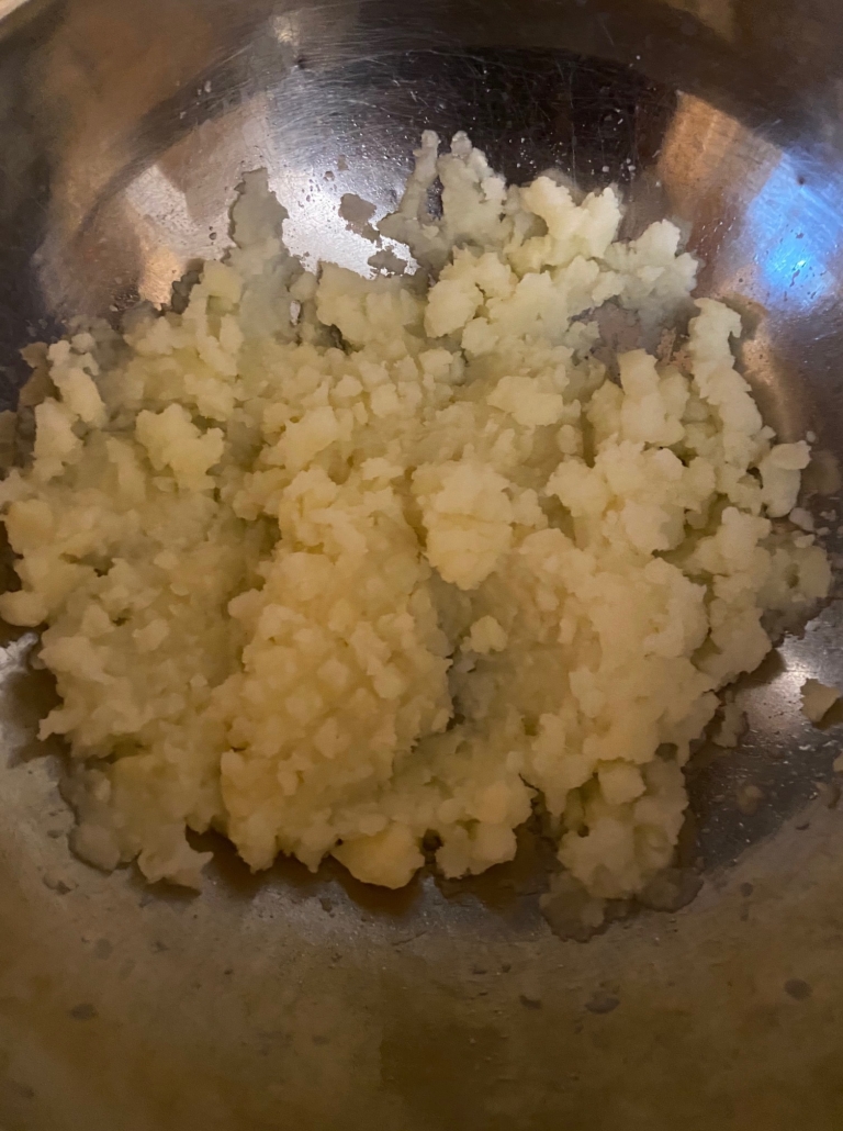mashing the potatoes