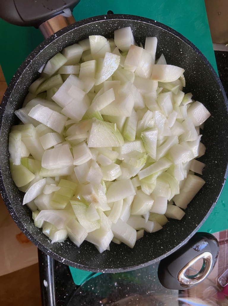 Putting onions and oil in pot to fry