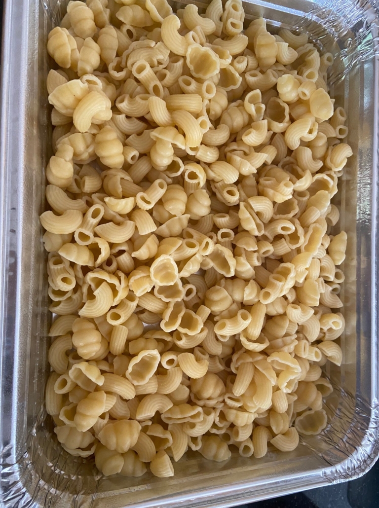 Cooked noodles in greased pan