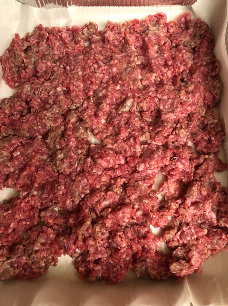chopped meat spread in parchment paper lined pan