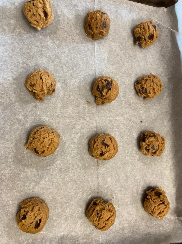 cookie dough on parchment lined baking sheets