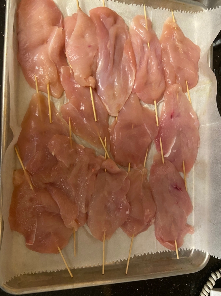 skewered chicken breast in a row