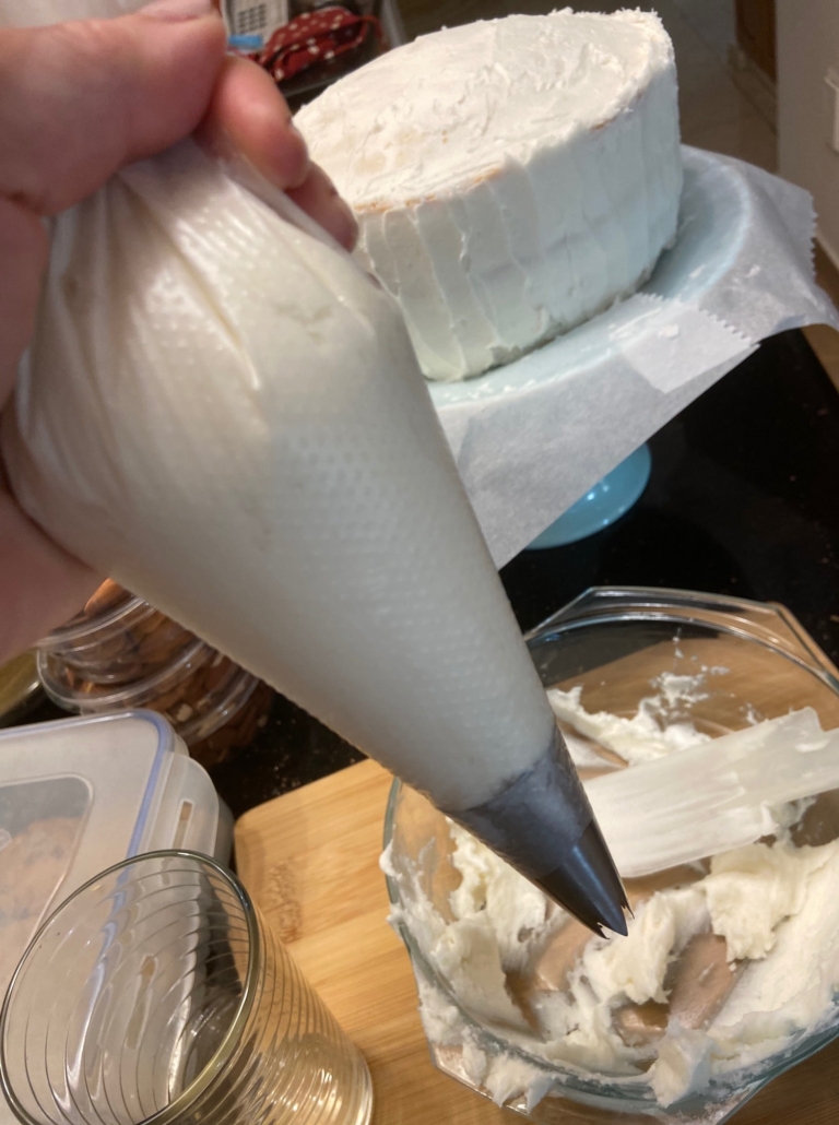 frosting in pastry bag with large tip