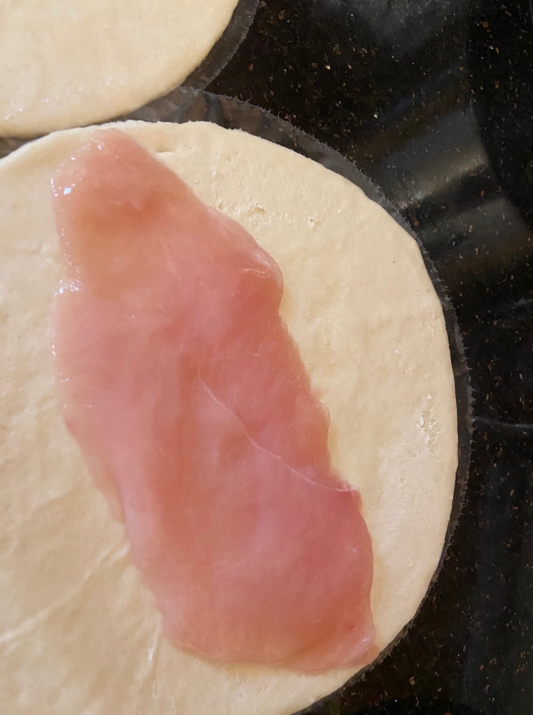 chicken breast on dough round