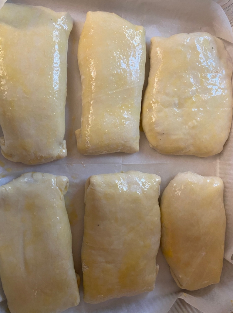 Lining up the wellingtons in the baking tin