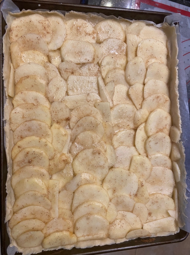 Overlapping apple slices on pastry