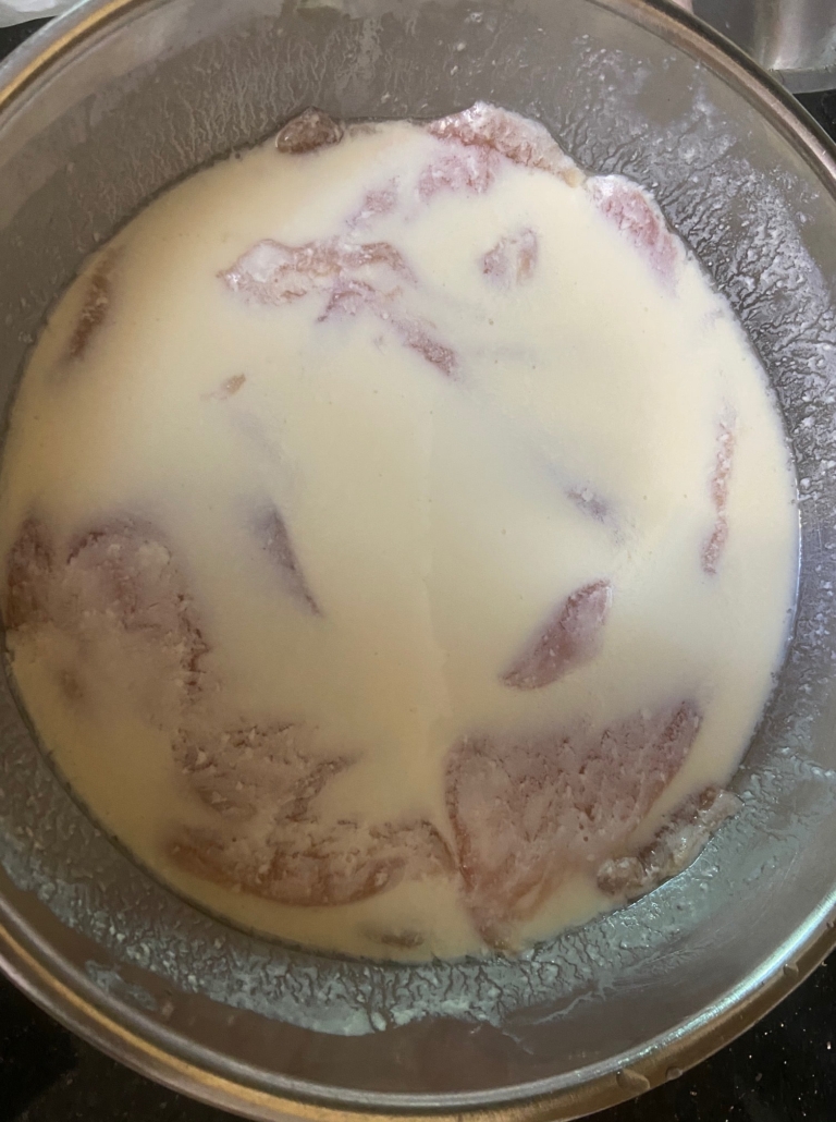 Shnitzel "bathing" in soy mixture