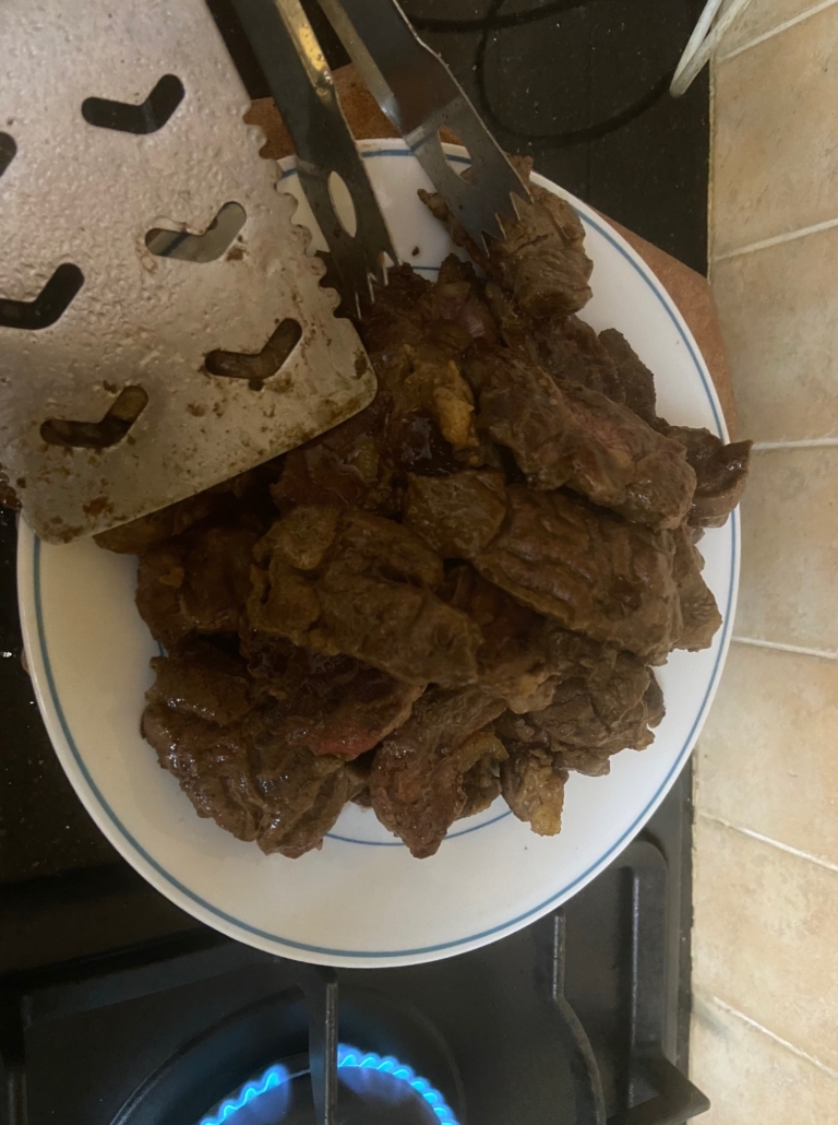 Piling the browned meat on a plate
