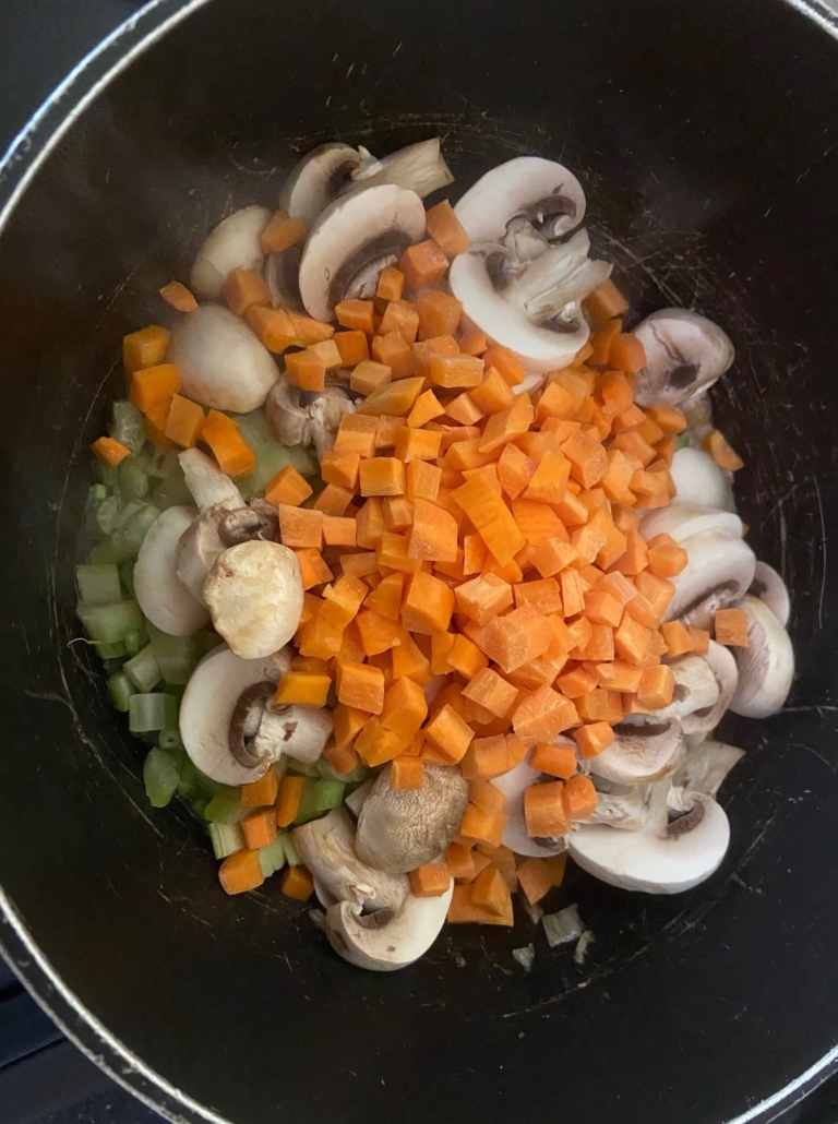 sauteeing veggies in oil in pot