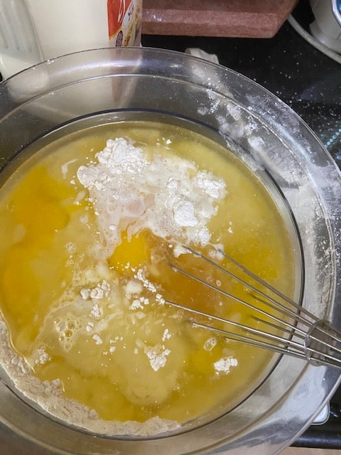 Adding the liquid ingredients to the dry