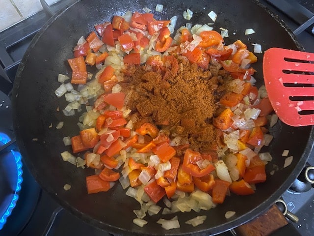 adding tomato and paprika