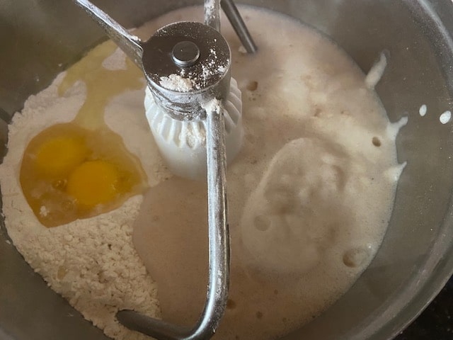 Adding eggs, oil, water and yeast mix