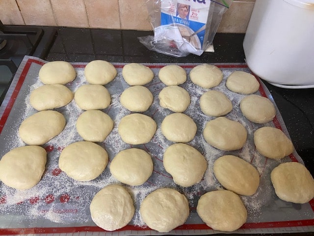 laying balls of dough on farina