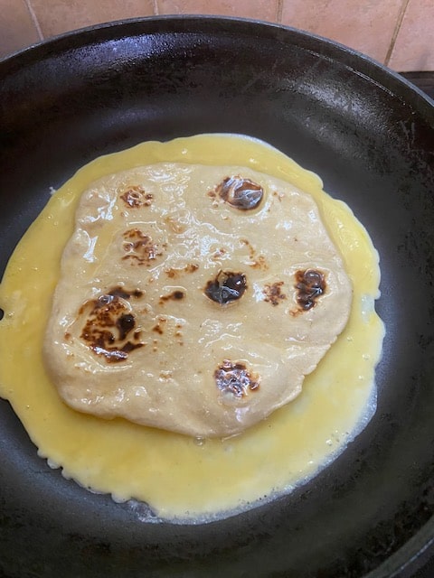 cooking first side of tortilla in egg