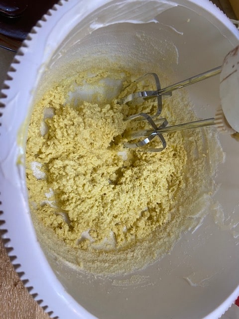 adding almond flour to eggs and sugar