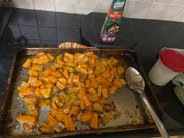 tossing sweet potatoes with chili sauce and sesames