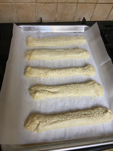 wetting the sticks on the parchment lined pan