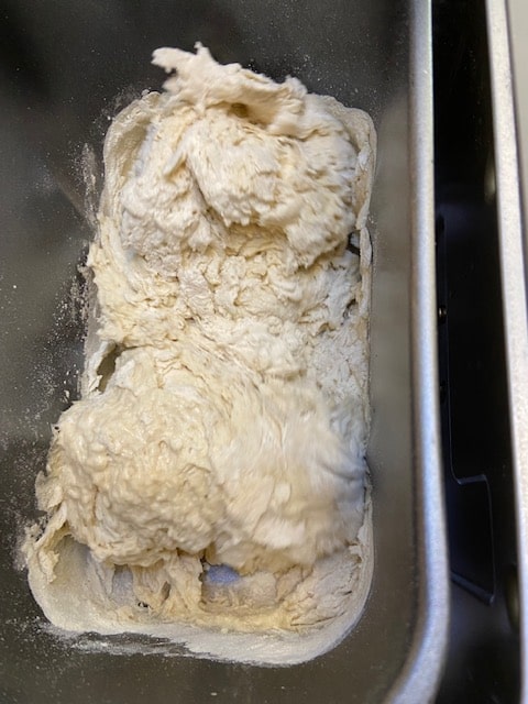 adding the ingredients to the poolish