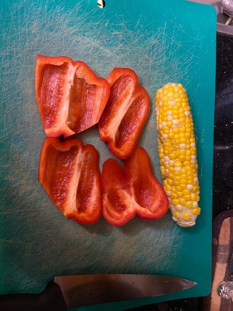 one red pepper and an ear of corn