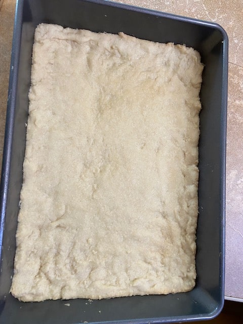crust dough patted on bottom and up sides of pan