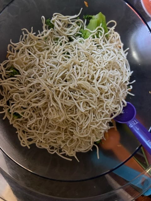 noodles crushed on top of broccoli