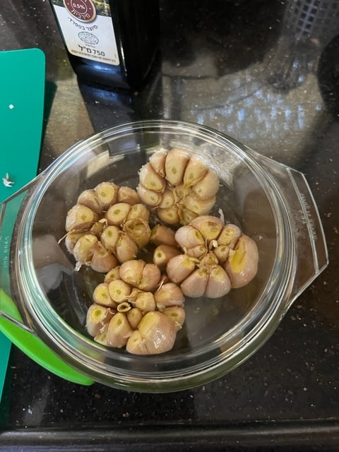 oil dribbled on garlic heads