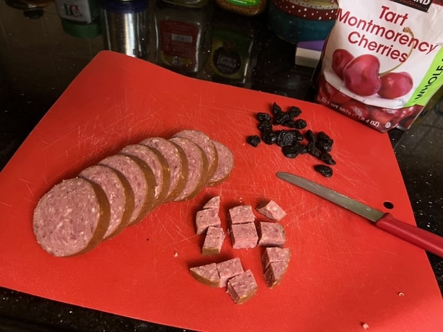chopping the cherries and salami