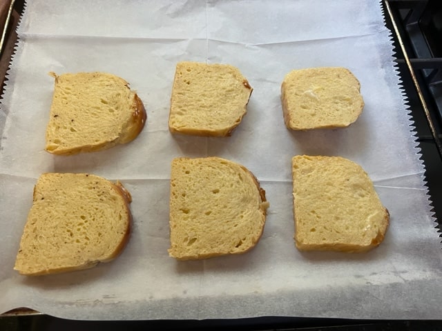 putting dipped bread on parchment/pan