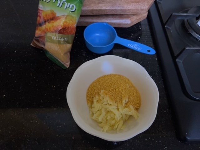toss breadcrumbs and cheese in bowl