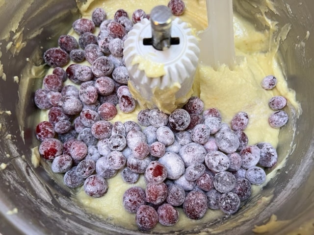 floured cranberries on top of batter